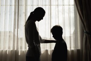 Parent comforting sad child giving emotional support care, and love 