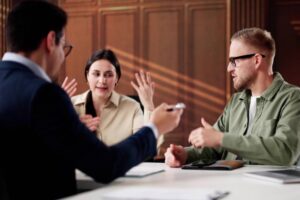 Young Couple Meeting With Family Divorce Lawyer For Financial Consulting.